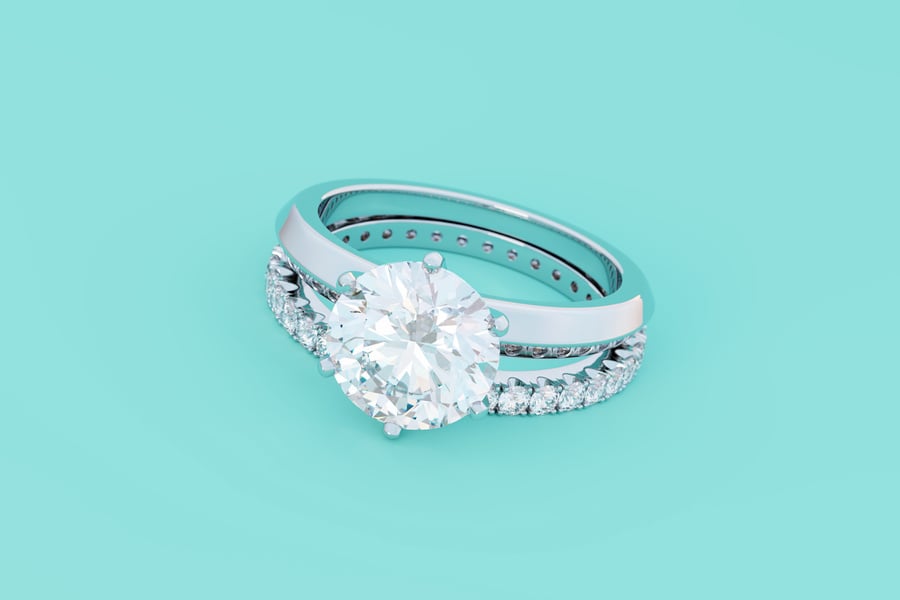 Diamond engagement ring, eternity wedding band on turquoise background.